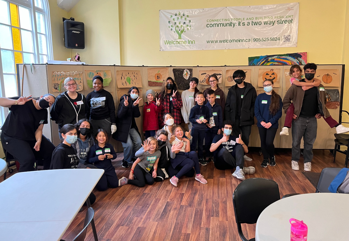 CVC volunteers with the children they mentor and tutor A group of children and mentors smiling and laughing