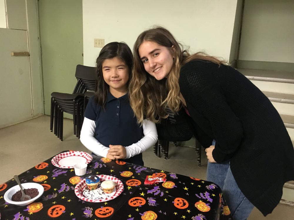 Volunteer and Child Volunteer and Child with cupcakes